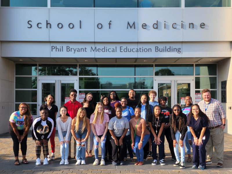 This group of high school students from across the state attended the July session of Mosaic. With them are Dakota Bibbs, far right, academic counselor for the School of Medicine, and, in front of him, Jessica McKenzie, a medical student who helped Mosaic students navigate the Medical Center.
