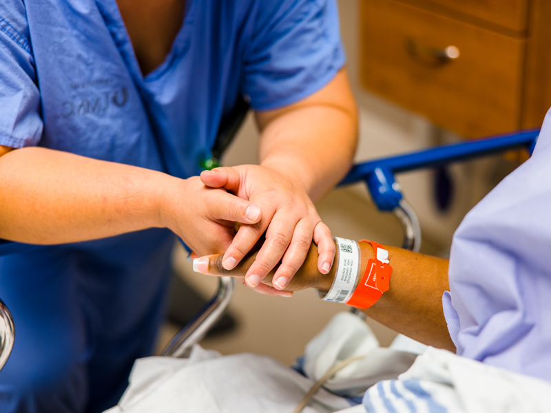 Dr. Felicitas Koller, associate professor of transplant surgery, reassures Tawanna Davis just before she's rolled to surgery. Koller transplanted into Davis' abdomen a kidney donated by Davis' son, Quinten Hogan. Lindsay McMurtray/ UMMC Communications