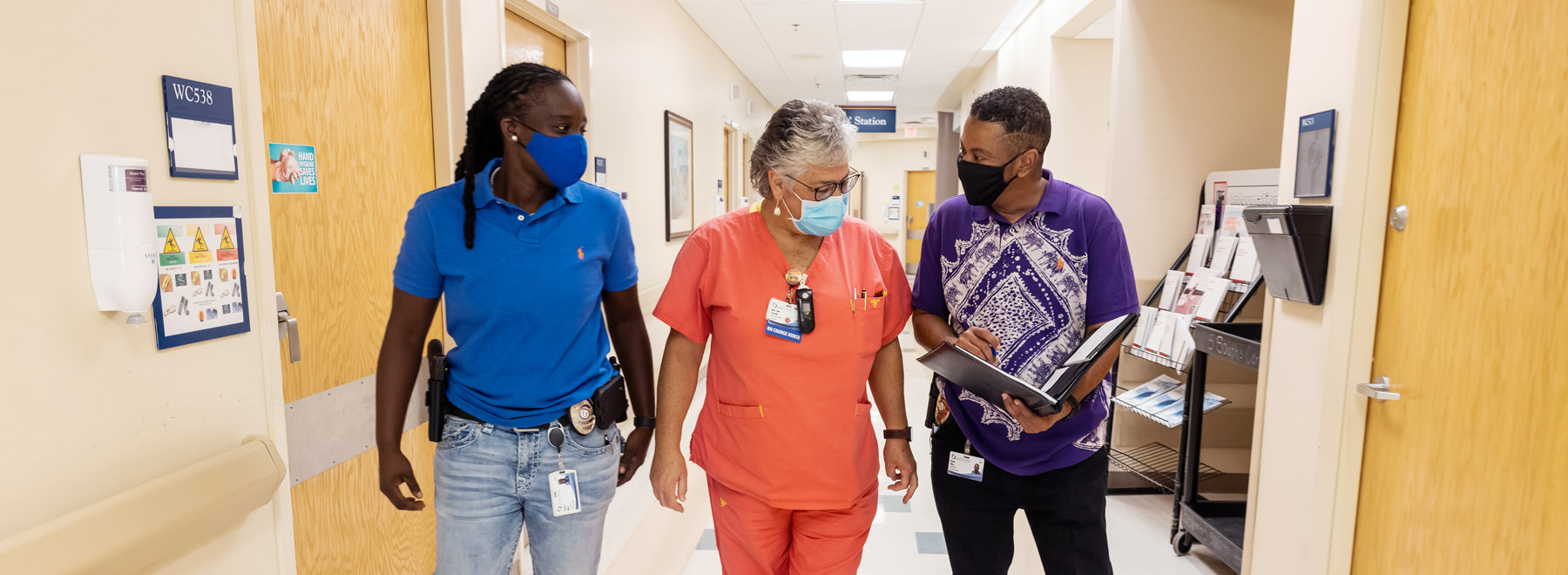 Officer Shanice Mays, left, talks with charge nurse Mary Jane Sistrunk and Sgt. Shaun Hiley about a patient's behavior on 5 South. Jay Ferchaud/ UMMC Communications