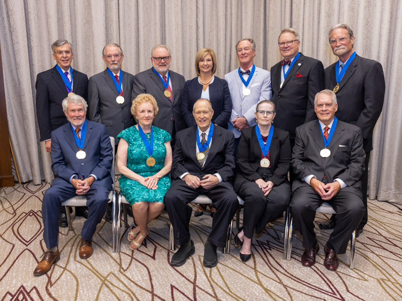 The Golden Graduates, with Dr. LouAnn Woodward, fourth from left, are, back row, from left, Dr. Claude Fox, Dr. Jon Michael Beall, Dr. John “Pat” Barrett, (Woodward), Dr. Michael P. Brooks, Dr. James Sones II and Dr. John Joseph Cook. Front row, from left: Dr. Joe Files, Dr. Louise Huffman Bethea, Dr. Edward Thomas James Jr., Dr. Margaret Michele Oates and Dr. Van Lemuel Lackey.  Other Golden Grads who were recognized: Dr. Bryan Barksdale and Dr. Lawrence Sollie Goldstein. not pictured, was also honored as a Golden Grad. Jay Ferchaud/ UMMC Communications 