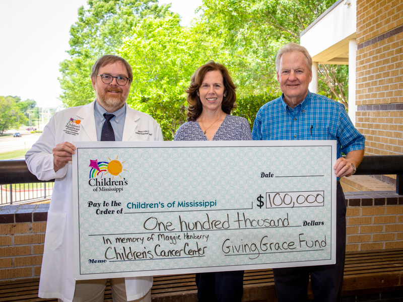 Dr. Anderson Collier, D. Jeanette Pullen Chair of Pediatric Hematology-Oncology at UMMC, division chief and director of the Center for Cancer and Blood Disorders at Children's of Mississippi, thanks Melissa and Phil Hanberry for the Giving Grace Fund's donation toward renovations of the center. Jay Ferchaud/ UMMC Communications