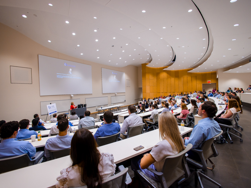 Dr. LouAnn Woodward, Vice Chancellor for Health Affairs and Dean of the School of Medicine, greet first-year medical students on their first day during Welcome Week.