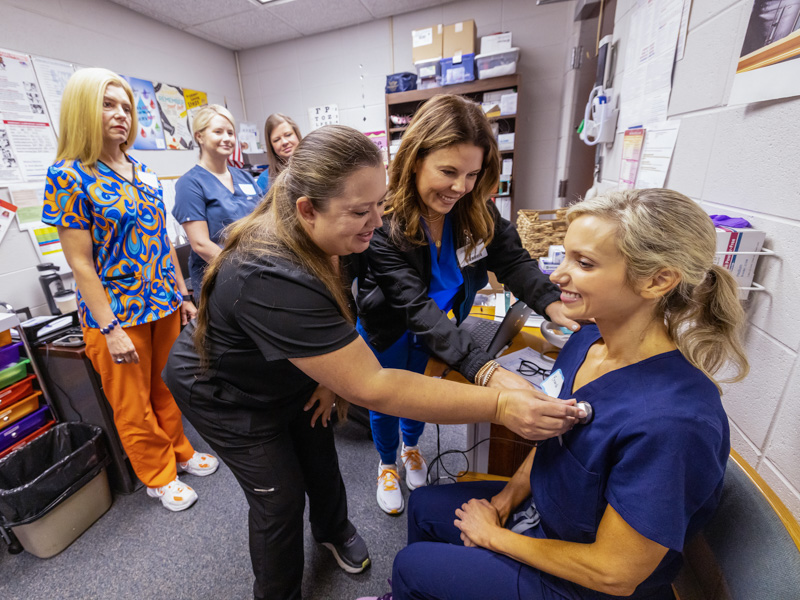 In this 2022 photo, UMMC School of Nursing educator Jolie D'Antonio, center, watches as Pearl School District head nurse Julie Thornton uses a digital stethoscope for a telehealth trial with Pearl Lower Elementary school nurse Aly Weems.