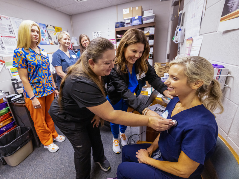 UMMC School of Nursing educator Jolie D'Antonio, center, watches as Pearl School District head nurse Julie Thornton uses a digital stethoscope for a telehealth trial with Pearl Lower Elementary school nurse Aly Weems. Jay Ferchaud/ UMMC Communications