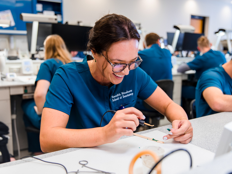 First-year School of Dentistry student Meredith Minshew practices hand dexterity during a waxing exercise.