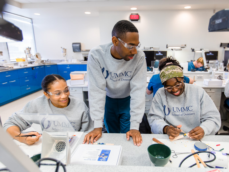 From left, first-year School of Dentistry students Ashley Lampkin, Blaine Turner and Ana Ivy complete an exercise that required them to fashion tiny figures from melted wax.