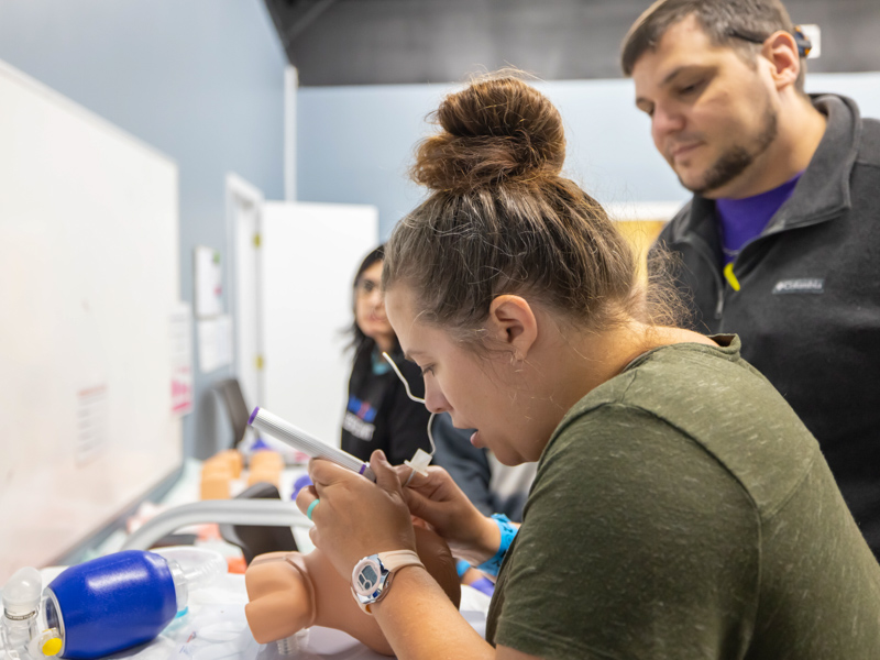 Magee General registered nurse Kelly Hayman and Magee General Hospital nurse practitioner Jonathan Giangrosso practice intubating a simulator newborn. Melanie Thortis/ UMMC Communications 