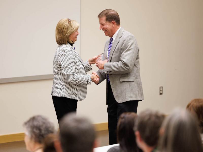 During the August 23 induction ceremony for the Academy for Excellence in Education, Dr. LouAnn Woodward, vice chancellor for health affairs and dean of the School of Medicine, congratulates one of the honorees, Dr. Mike McMullan, professor of medicine, director of the Division of Cardiology and associate dean for Student Affairs in the School of Medicine. Joe Ellis/ UMMC Communications 