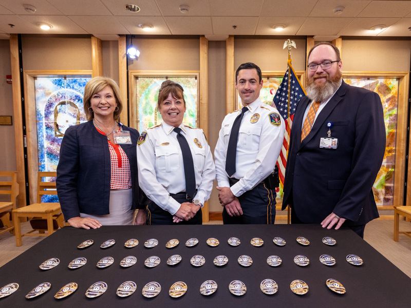 From left, Dr. LouAnn Woodward, Police and Public Safety Chief Mary Paradis and Joshua Bromen, and Dr. Jonathan Wilson. Jay Ferchaud/ UMMC Communications 