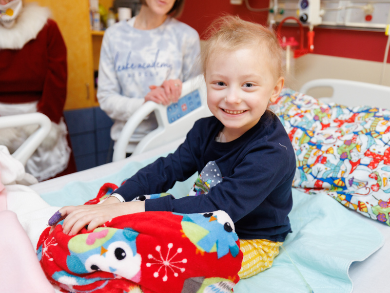 Mary Mosley Pickering, a patient in the Children's of Mississippi, is thrilled to get a visit from Santa and Mrs. Claus. Joe Ellis/ UMMC Communications 