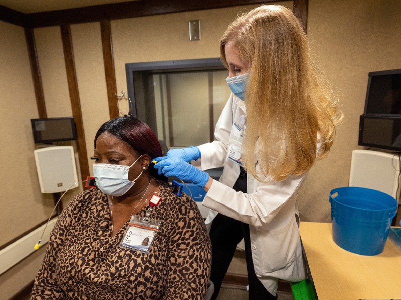 Dr. Mary Frances Johnson prepares patient Keela Foy for a hearing test in the Division of Audiology within the Department of Otolaryngology - Head and Neck Surgery. Jay Ferchaud/ UMMC Communications