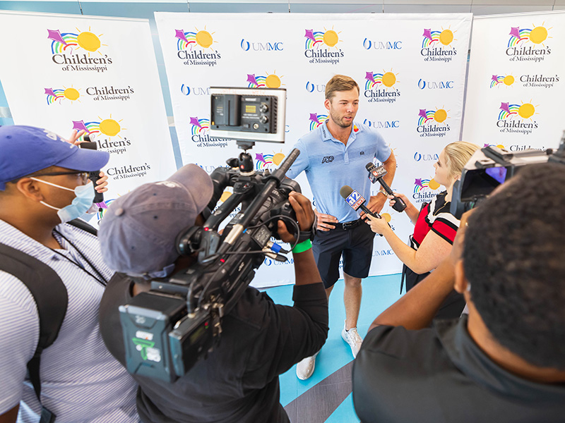Burns, winner of the 2021 Sanderson Farms Championship and 12th in the Official World Golf Rankings, talks with the media during a visit to the state's only children's hospital.