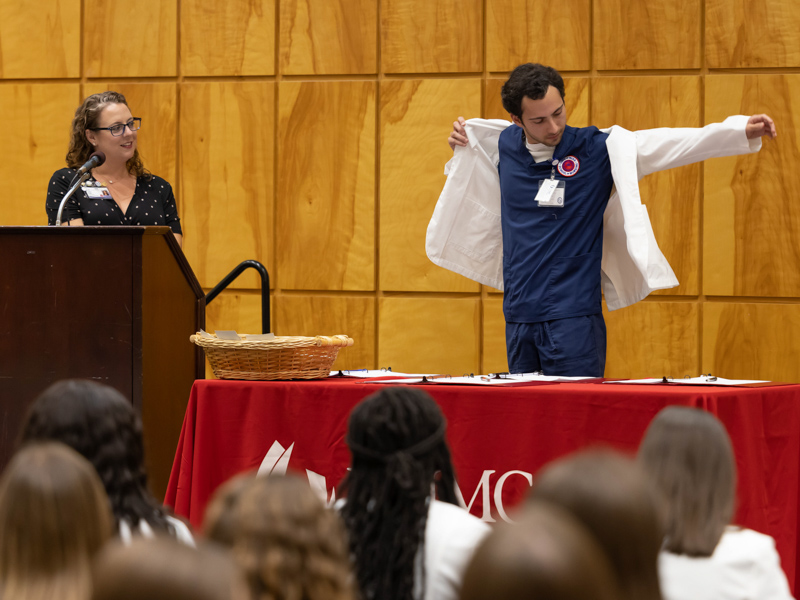 Brantley "Mack" Davis dons his white coat, signaling the start of the clinical part of his nursing education at UMMC. Melanie Thortis/ UMMC Communications