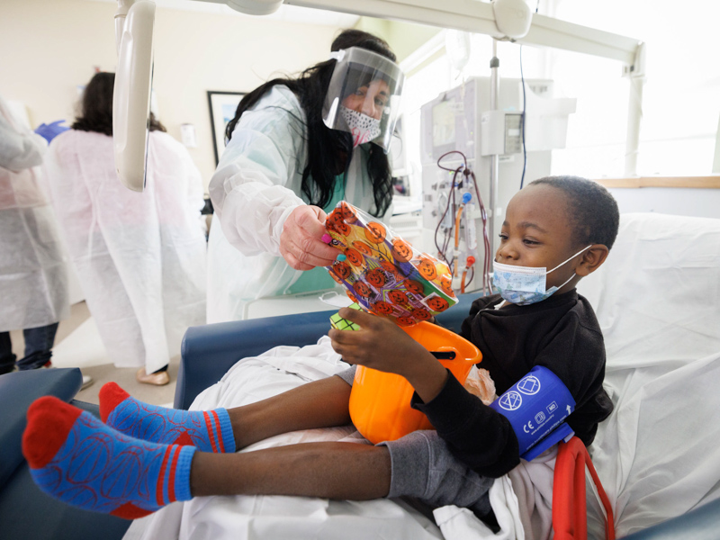 Hospital School teacher Christian Steverson shares Halloween goodies with Children's of Mississippi patient Kobe Edget of Grenada. Joe Ellis/ UMMC Communications 