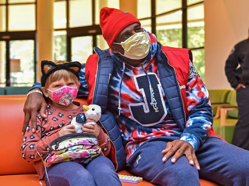 Children's of Mississippi patient Hadley Black of Pearl gets an Aflac duck from Jackson State's Deion 