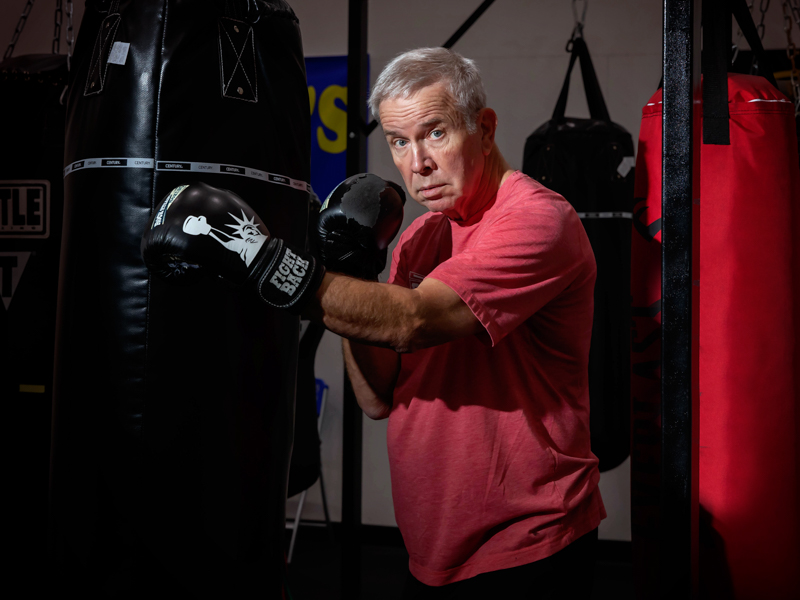 Wall Mural Latin Boxers doing some training on a punching bag at a