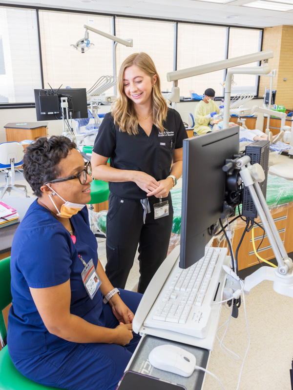 Dr. Kimberly Wade, left, and fourth-year student Sara Grace Valentine peruse the scans of Valentine's patient.