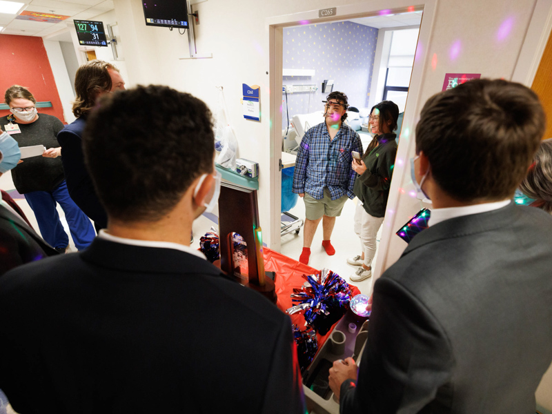 Children's of Mississippi patient Campbell Smith and his mom, Leah Smith of Brookhaven, get a visit from Ole Miss baseball players and their 2022 College World Series trophy. Joe Ellis/ UMMC Communications