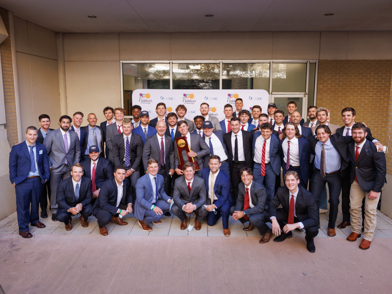 The University of Mississippi baseball team, winners of the 2022 College World Series, and coach Mike Bianco smile for a photo at the Rainbow Garden at Children's of Mississippi. Joe Ellis/ UMMC Communications 