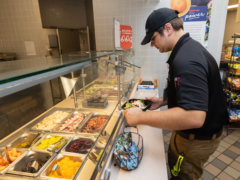 Wil Taylor, a barrier management specialist with UMMC Environmental Health and Safety, chooses a healthy salad for lunch at the Student Union cafeteria.
