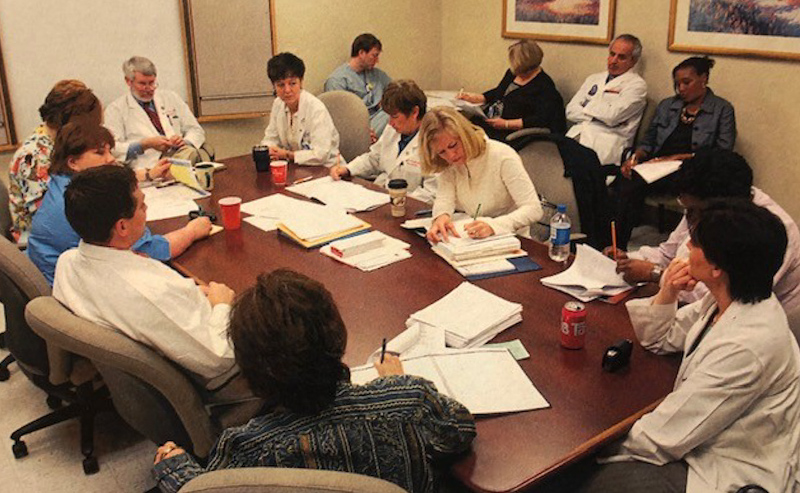 The BMT transplant team meets to discuss patients in this 2006 photo.