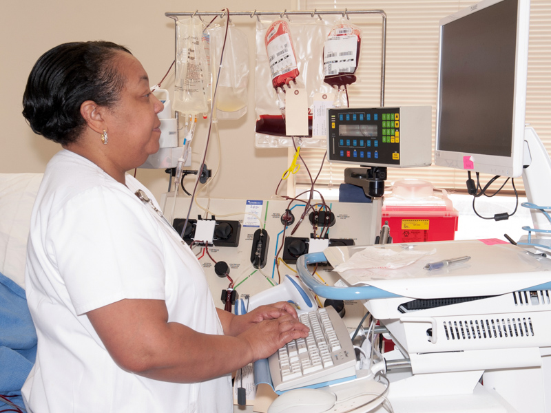 This 2014 photo shows registered nurse Marcia Gates working in the apheresis room.
