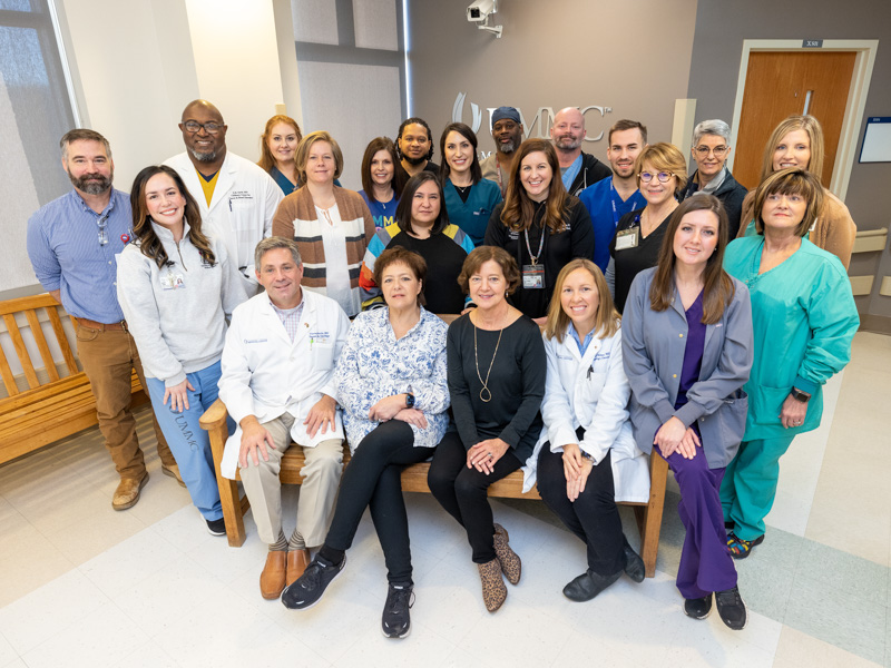 The bone marrow transplant team at UMMC counts providers that include physicians, nurse practitioners, nurses, pharmacists, medical technologists, apheresis staff and more. Those pictured are, from row from left, medical technologist Edward “Ford” Lofton, RN Michell Kimble, Dr. Vince Herrin, BMT nurse manager Pam Farris, Dr. Carolyn Bigelow, Dr. Carter Milner, and RNs Jennifer Rouse and Sherry Allen; second row, from left, Dr. Dereck Davis, nurse practitioner Dana Delaski, RN Maria Dupree, nurse practitioner Sarah Elizabeth Elkin, RN Patty Burrow, nurse practitioner Kim Clyde; third row, from left, medical technologist Dianne Cone, RN Melanie Watkins, nurse practitioner Ashley Peden, RN Caleb Pace, Dr. Tereza Holman; and back row from left, RNs Shelby McNair and Ronnie Edwards and pharmacist Justin Harrison. Jay Ferchaud/ UMMC Communications
