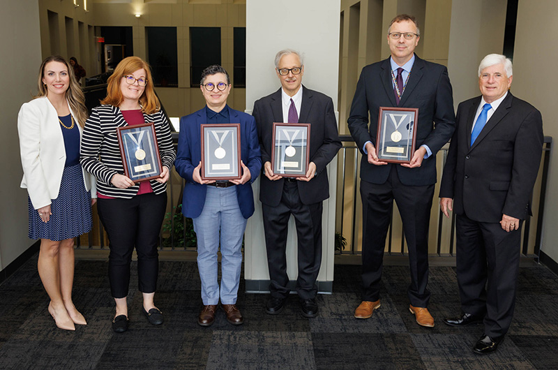 Gold award recipients, from second left to right, are Dr. Erin Taylor, Dr. Norma Ojeda, Dr. William Hillegass and Dr. Yann Gibert. Not pictured are Dr. Sarah Glover and Dr. Michael Griswold.