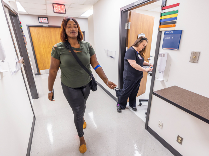 Registered nurse Katherine Speer, a ventricular assist device coordinator, leads Garner through an assessment to check for frailty during a follow-up visit at the Advanced Heart Failure Clinic.
