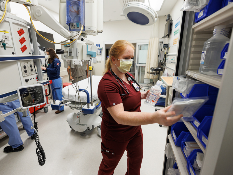 Emergency Medicine resident Dr. Emily Golan stocks supplies in a trauma room in the Adult Emergency Department at the University of Mississippi Medical Center.