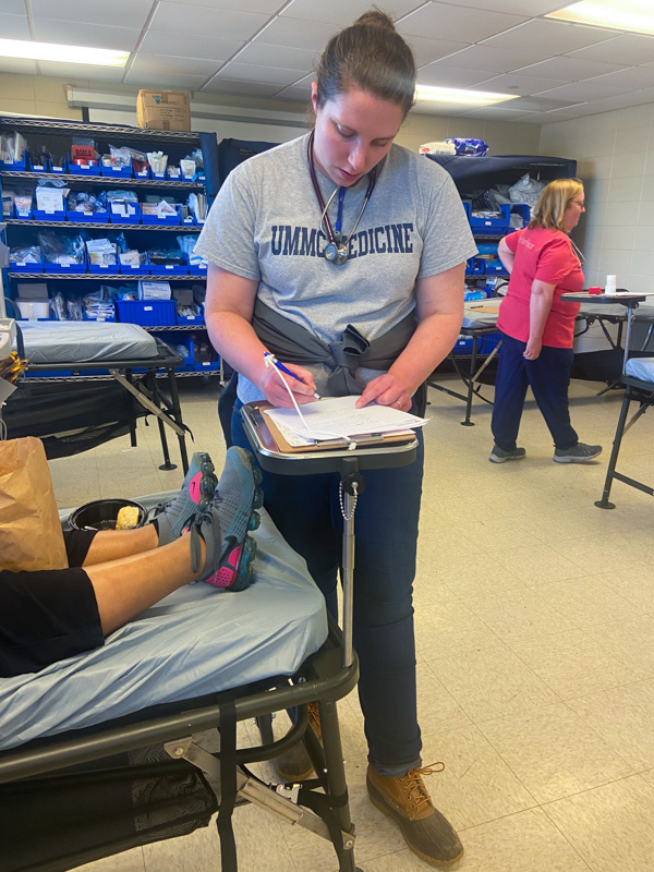 School of Medicine graduate and emergency medicine physician Dr. Margaret Shepherd treats a storm victim at a triage center set up in Rolling Fork.