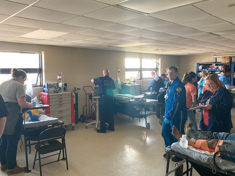 AirCare critical care paramedic and flight nurse Kevin King, in blue jumpsuit, was among Medical Center emergency personnel and Mississippi Center for Emergency Services staff and providers who treated patients in a triage center set up in Rolling Fork.