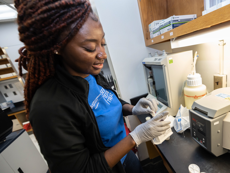 Nykeria Mcdougle, a cytotechnician in the cytology lab at UMMC, prepares patient specimen for testing as part of the See, Test & Treat event at the Jackson Medical Mall.