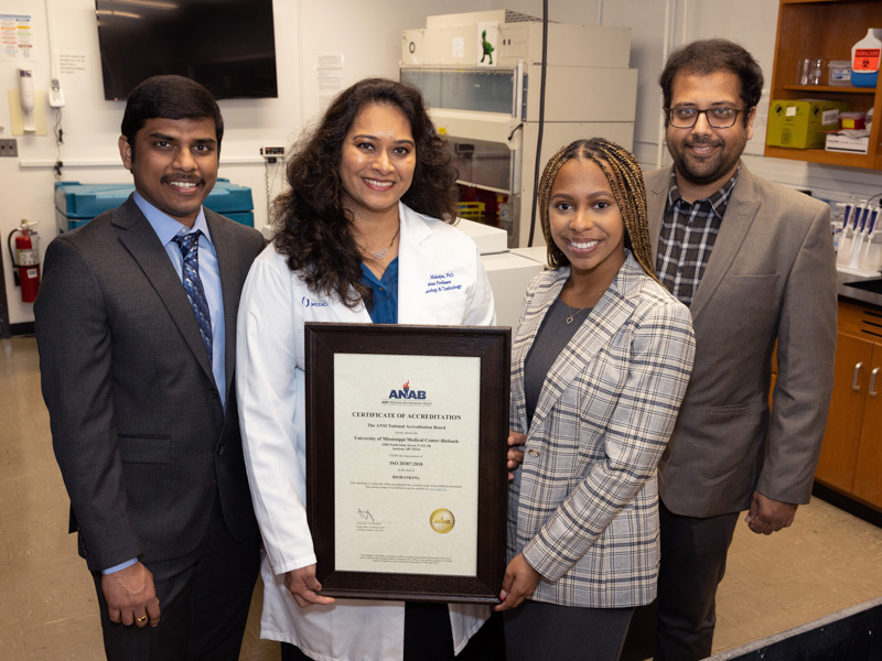 Venkata Seerapu, clinical research coordinator, Dr. Gouri Mahajan, UMMC Biobank director, Assata-Senghora Demyers, researcher and Tapan Rajguru, biorepository specialist, hold the biobank's certificate of accreditation.