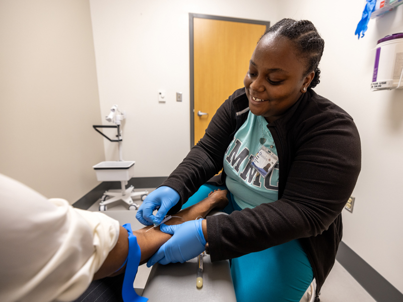 RN coordinator Stacey Porter collects a participant’s blood sample. During each visit, about 3 tablespoons of blood are drawn to examine how the Immulina supplement impacts certain immune-related biomarkers.