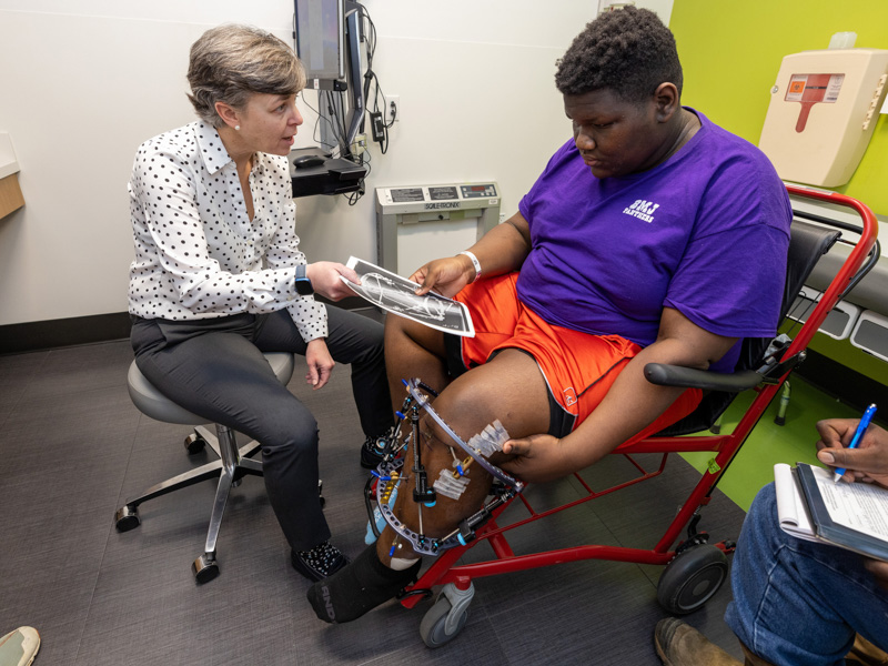 Dr. Kellie Leitch shows Paul Sykes III his X-rays during a visit to the Kathy and Joe Sanderson Tower at Children's of Mississippi.