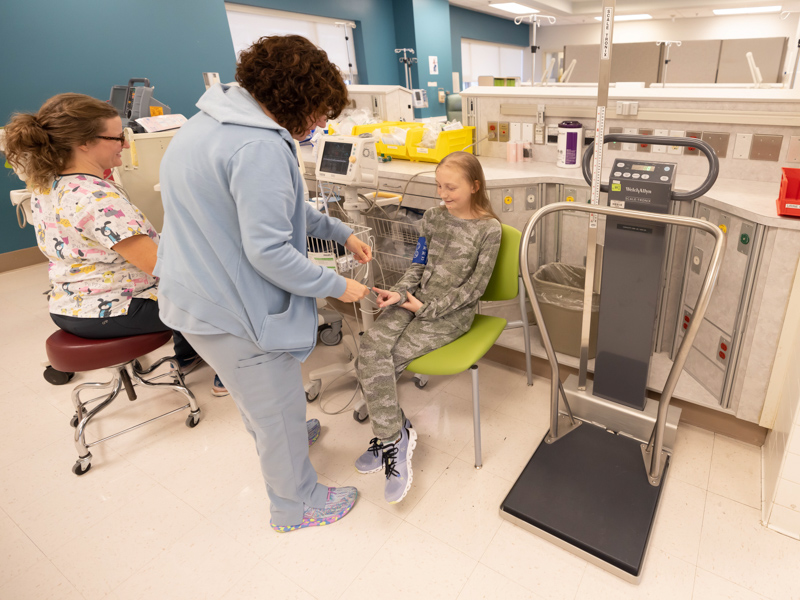 Oncology nurses Allie Herrmann, far left, and Carey Graves take the vital signs of patient Mabrey Logan of Brandon at the new temporary location of the Center for Cancer and Blood Disorders.