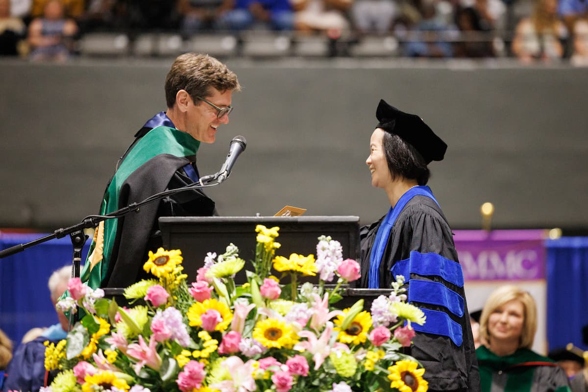 Dr. Thomas Dobbs presents Yan Gao with the John D. Bower Award.