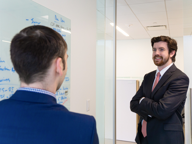 2023 School of Pharmacy graduate Dylan Edwards discusses policy ideas with Kyle Robb, PharmD, director of state policy and advocacy with the Office of Government Relations of the American Society of Health-system Pharmacists.