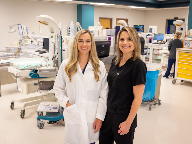 Dr. Lauren Tucker, associate professor of pediatrics and Emily Fratesi, research nurse manager, stand among isolettes in the Wiser NICU.