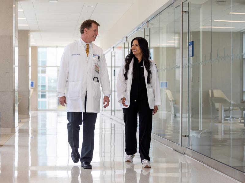 Dr. Michael McMullan, left, was not only Ruhi Randhawa's dean for her residency application, he is also her physician. Jay Ferchaud/ UMMC Communications 