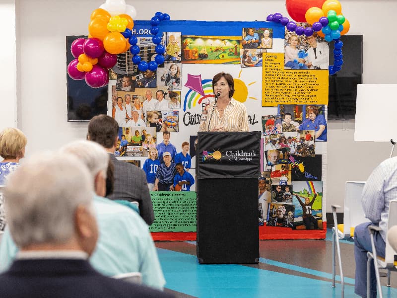 Dr. Mary Taylor, Suzan B. Thames Chair and professor of pediatrics, welcomes attendees to a presentation from the Sidney P. Allen and Friends of Children's Hospital Child Life Fund.