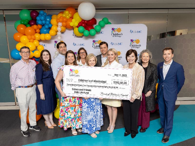 Celebrating the Sidney P. Allen and Friends of Children's Hospital Child Life Fund are, from left, businessman and philanthropist Billy Van Devender; Friends of Children's Hospital executive director Caitlin Foreman; Josh Odom; Rachel Allen Odom; Kristin Kappler Hardy, Children’s of Mississippi’s director of quality and clinical support services; Deborah Allen; Sidney Allen Jr.; Kristin Allen; Dr. Mary Taylor, Suzan B. Thames Chair and professor of pediatrics; Ellen Hansen, Children's of Mississippi chief nursing and clinical services officer; and John Scarbrough, board chairman of Friends of Children's Hospital.