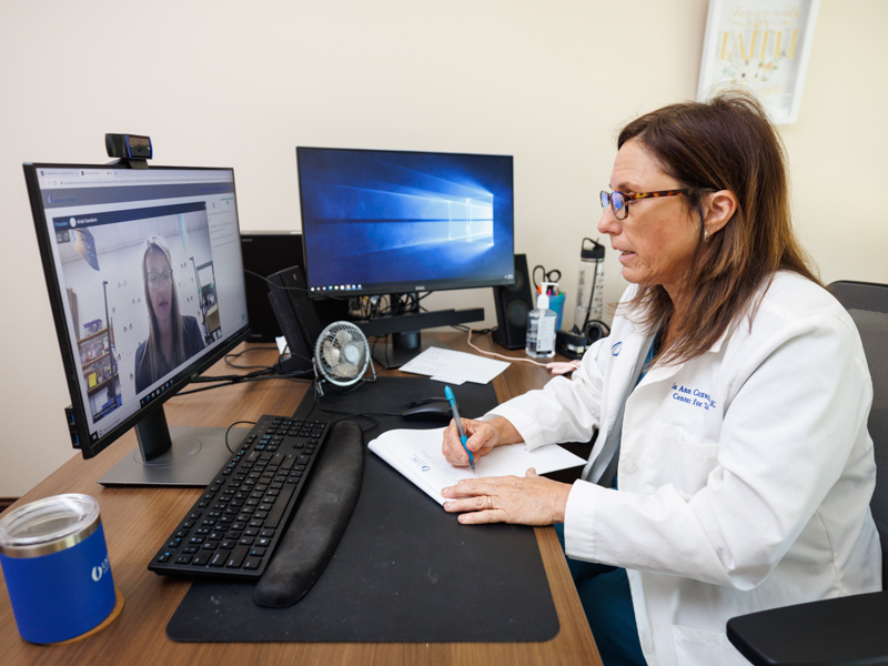 Lea Ann Coxwell, a nurse practitioner in the UMMC Center for Telehealth, conducts a telehealth visit to discuss a student's care with Jana Miller, a registered nurse serving as school nurse in Greene County.