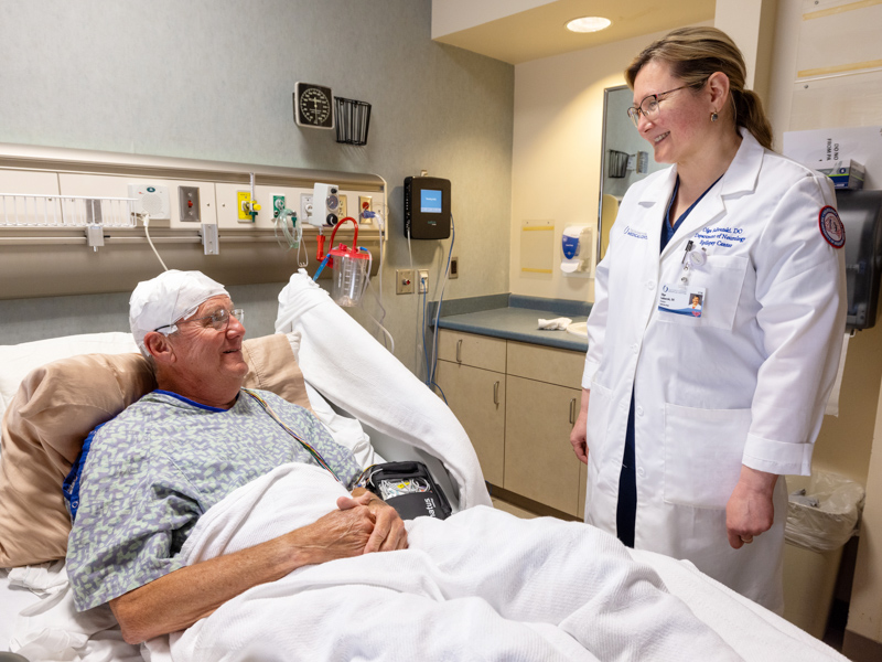 William Moore of Raymond chats with his neurologist, Dr. Olga Selioutski, professor of neurology, in the Epilepsy Monitoring Unit.