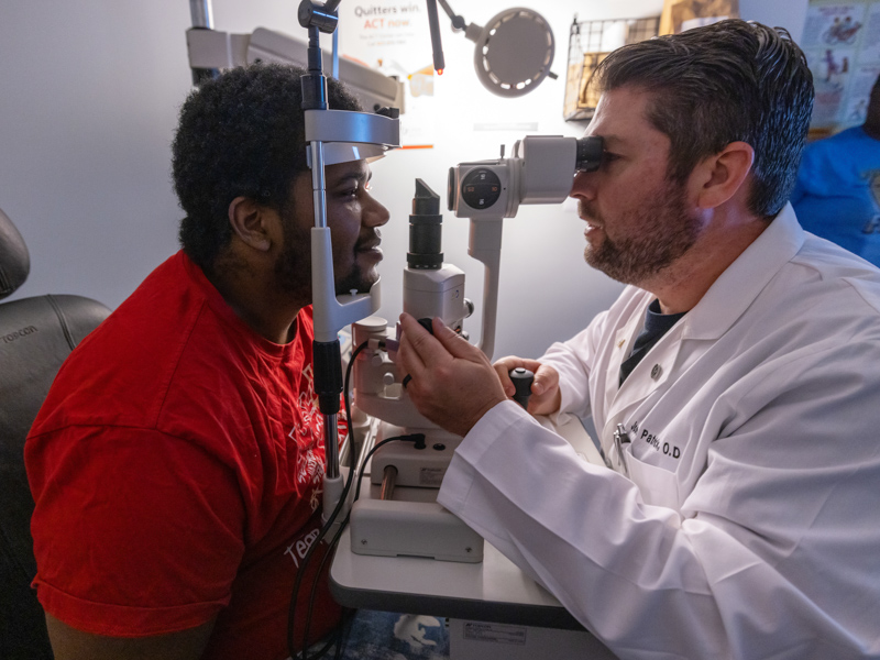Laurel optometrist Dr. Josh Patrick examines the eyes of JFC Vision Clinic patient Marquise McClenty of Jackson.