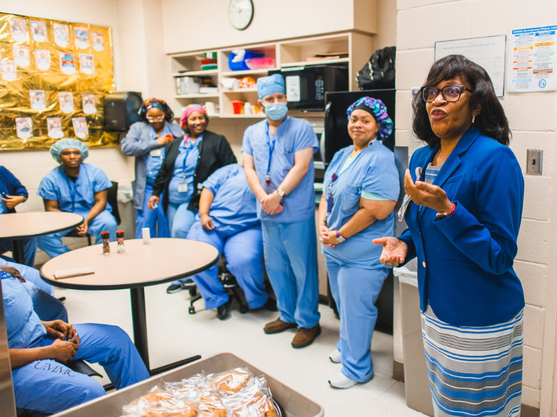 Dr. Kris Cherry, chief nursing executive, talks with members of UMMC's Sterile Processing Department during rounds. Lindsay McMurtray/ UMMC Communications