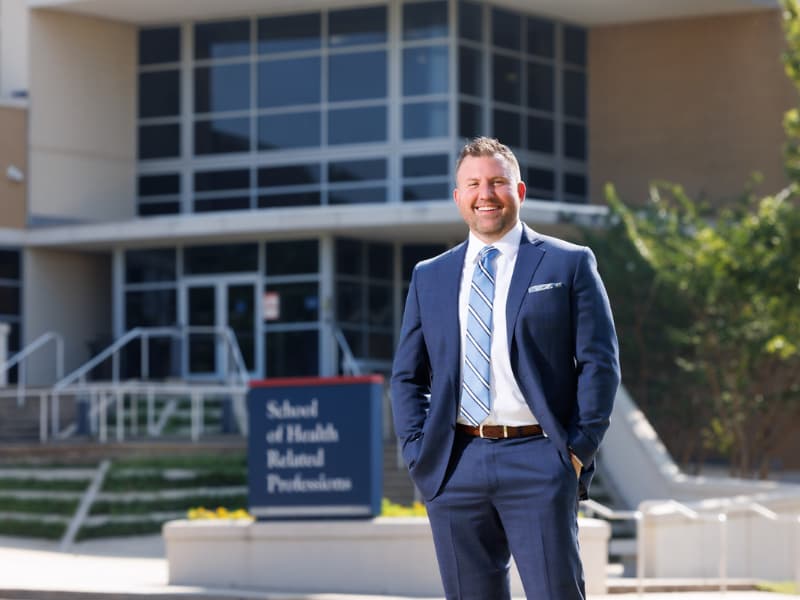 Dr. Jay Garner stands outside the School of Health Related Professions.