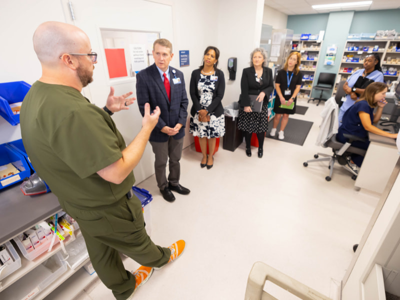 Assistant director of pharmacy services Andy Ostrenga speaks with Children's of Mississippi leaders during rounds. Melanie Thortis/ UMMC Communications 