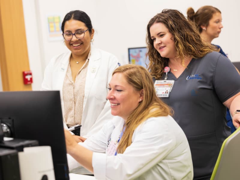 Spina bifida clinic team members, from left, medical student Simranjit Kaur, spina bifida nurse coordinator Laiken Moore and Dr. Kristin Weaver, clinic director, prepare for the first patient of the day.